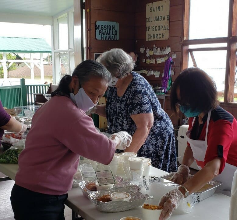 Volunteers pack food bags at St. James Church