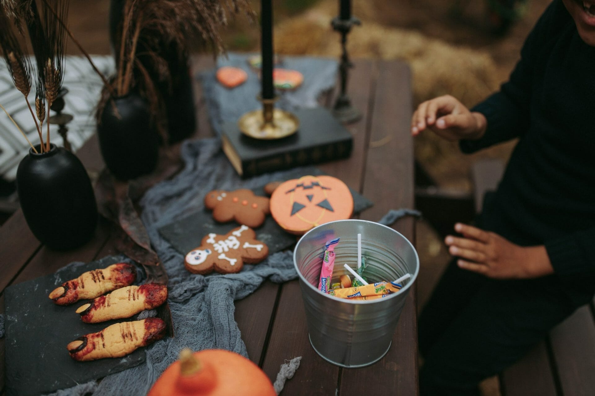 kids hands play over a table covered with Hawai'i Island Halloween items